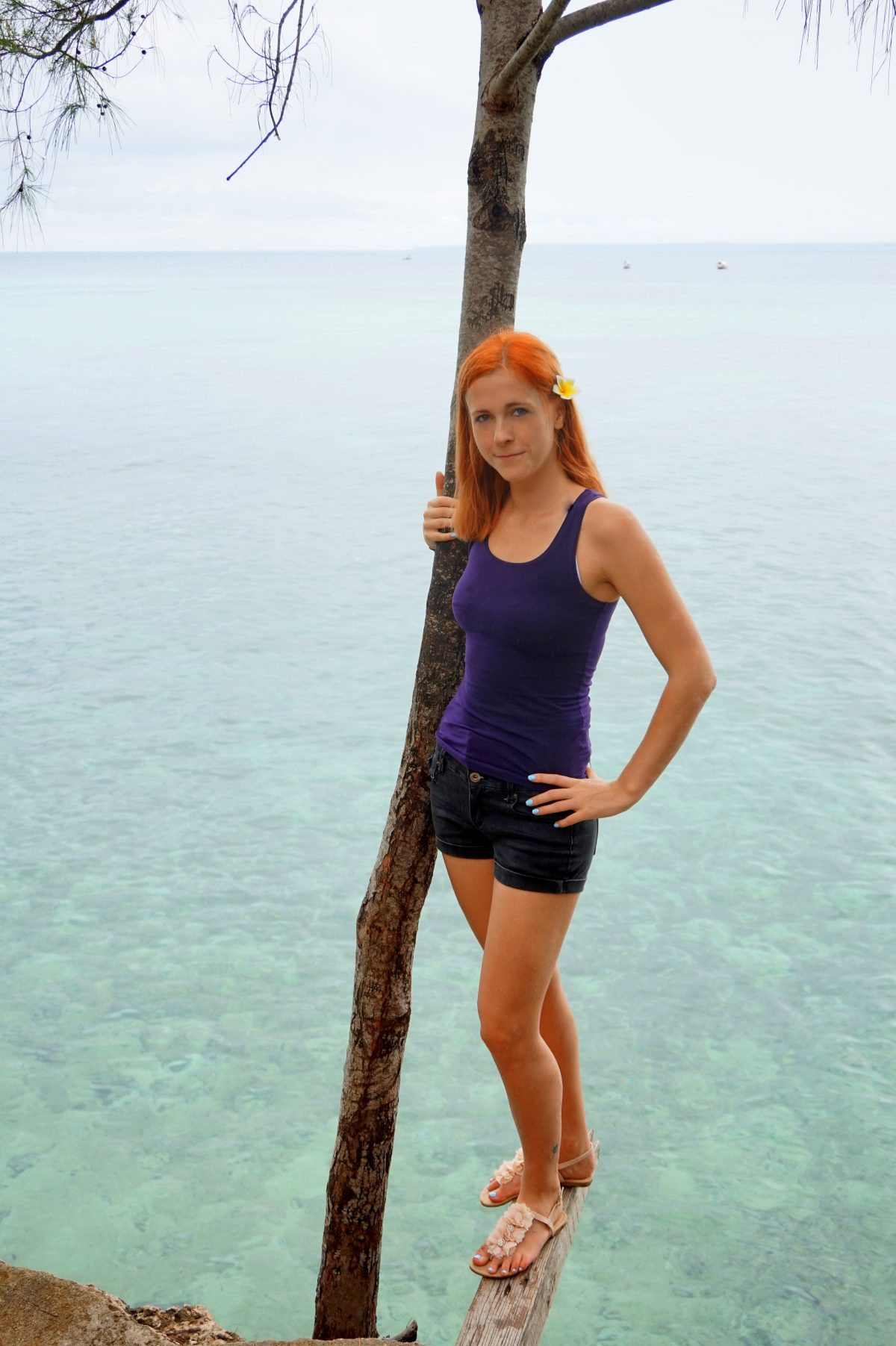 Anna standing in front of the clear blue waters of Stone Town, Zanzibar 