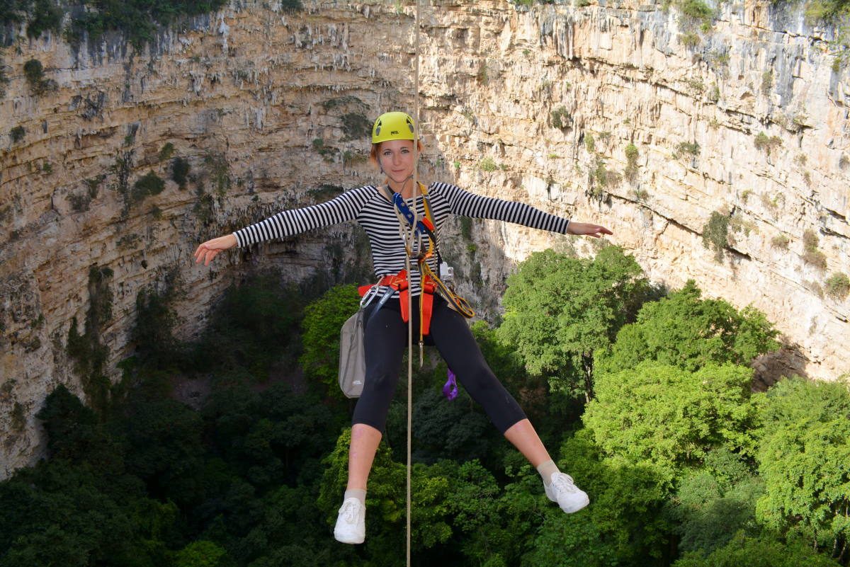A daring traveler rappels down into the depths of a massive sinkhole, an adventure in one of the many unique places Mexico has to offer.
