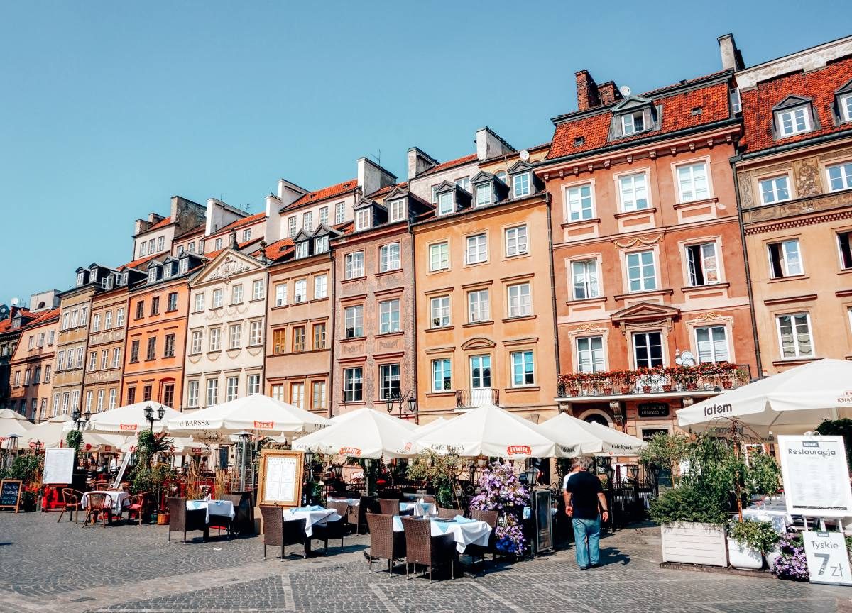 Warsaw The charming old town square in Warsaw, lined with colorful buildings and outdoor cafés, is a vibrant place to visit in Poland.