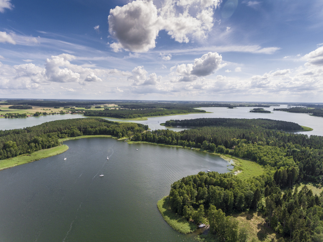 Masurian Lake District An aerial view of the serene lakes and lush greenery in the Masurian Lake District, a natural paradise for visitors in Poland.