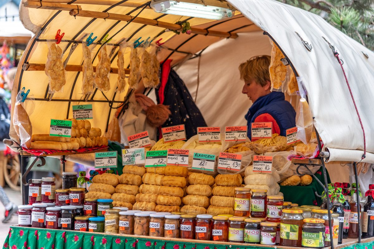 oscypki A traditional Polish market stall brimming with local cheeses and goods, inviting visitors to taste the flavors of Poland.