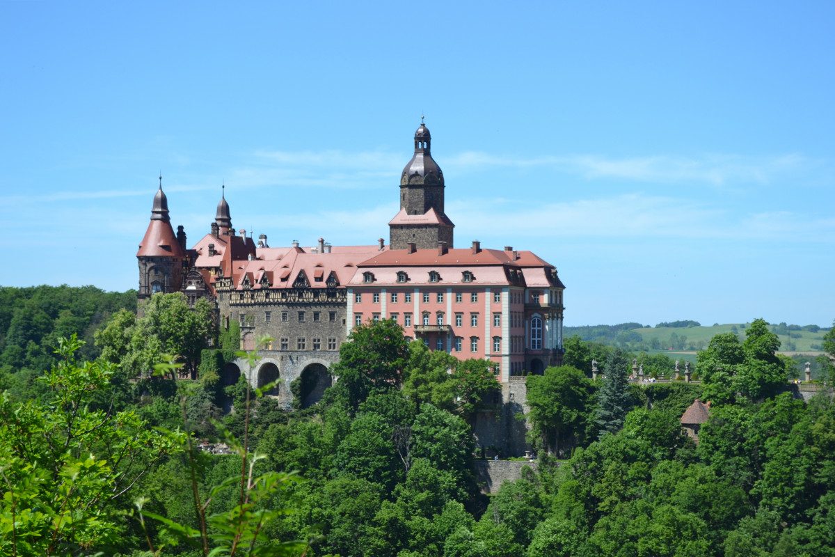 Ksiaz Castle The imposing Książ Castle, nestled among verdant trees, is a striking example of Poland's numerous castles rich in history and legend.