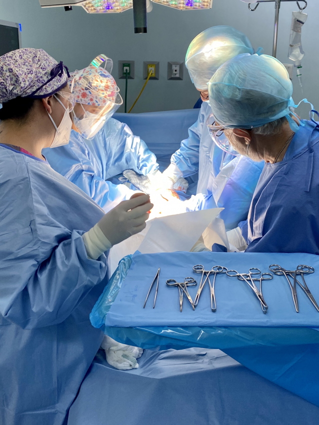 Medical team in scrubs performing a C-section birth in a Mexican hospital
