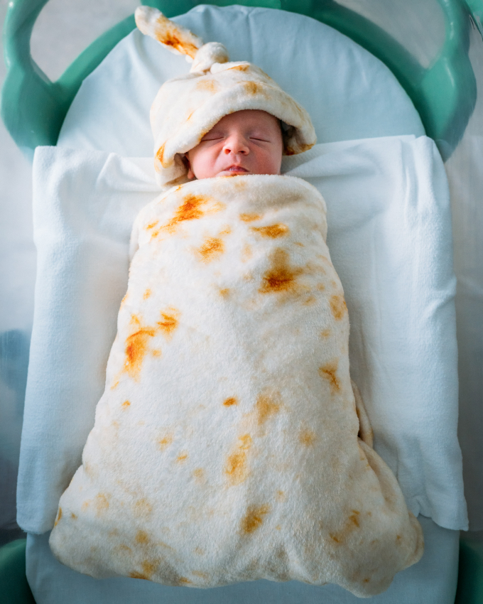 Newborn baby wrapped in a tortilla blanket after birth in Mexico.
